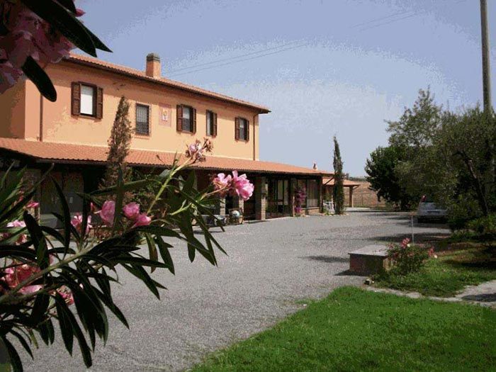 The Casale, its ochre walls behind an oleander in flower, at the end of the gravel drive.
