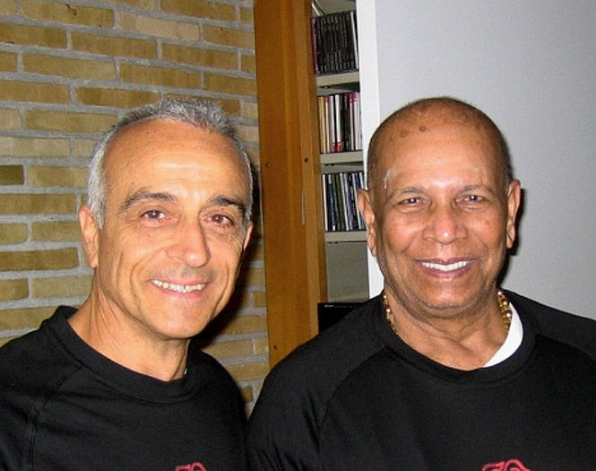 Lino Miele and Sri K. Pattabhi Jois side by side, both laughing.