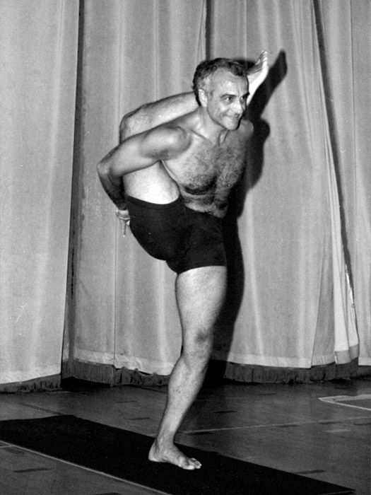 A standing balance photographed in black and white against a curtain.